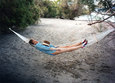 Photo of a woman relaxing at the river